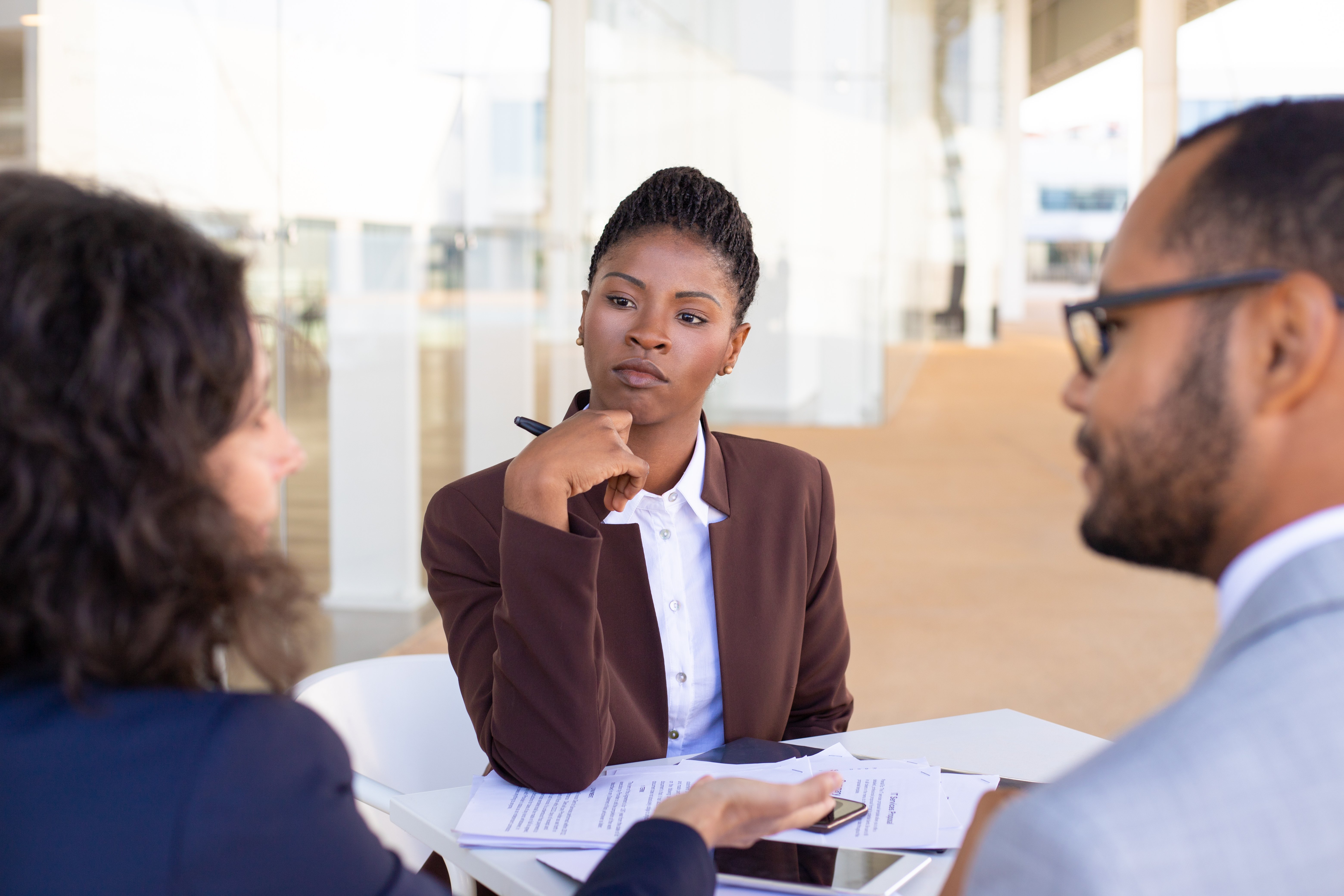 multiethnic-business-partners-discussing-contract-terms