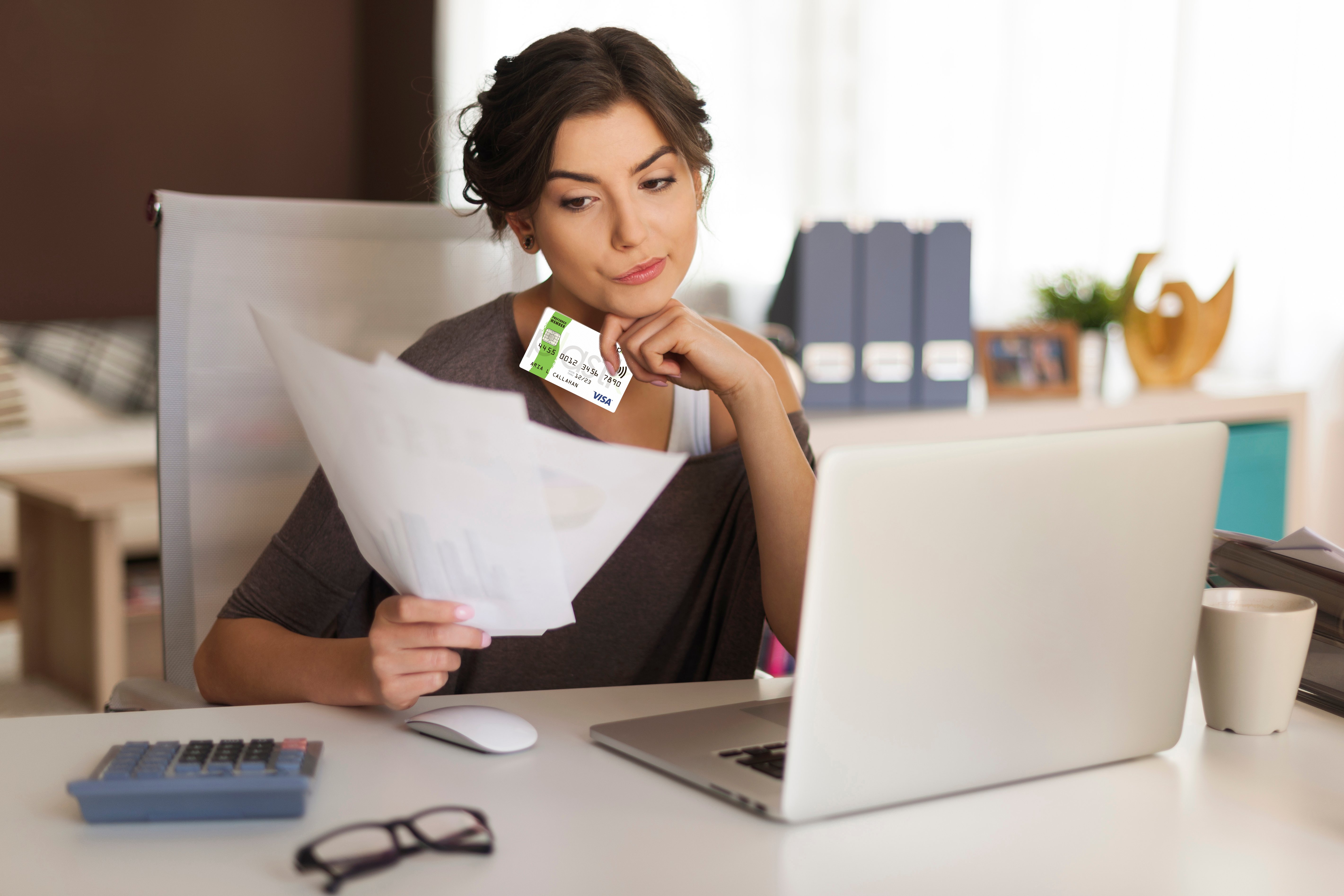 pensive-woman-paying-bills-home